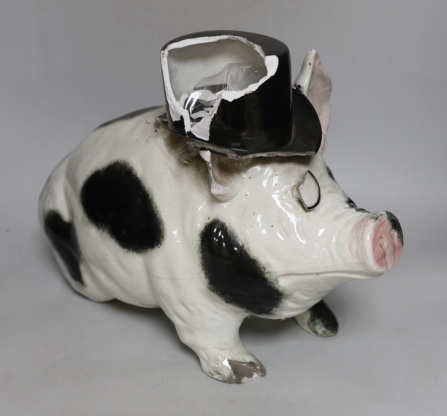 A large and rare Wemyss pig, with top hat and monocle, impressed mark WEMYSS WARE, R.H. & S, 45cm in length, a/f